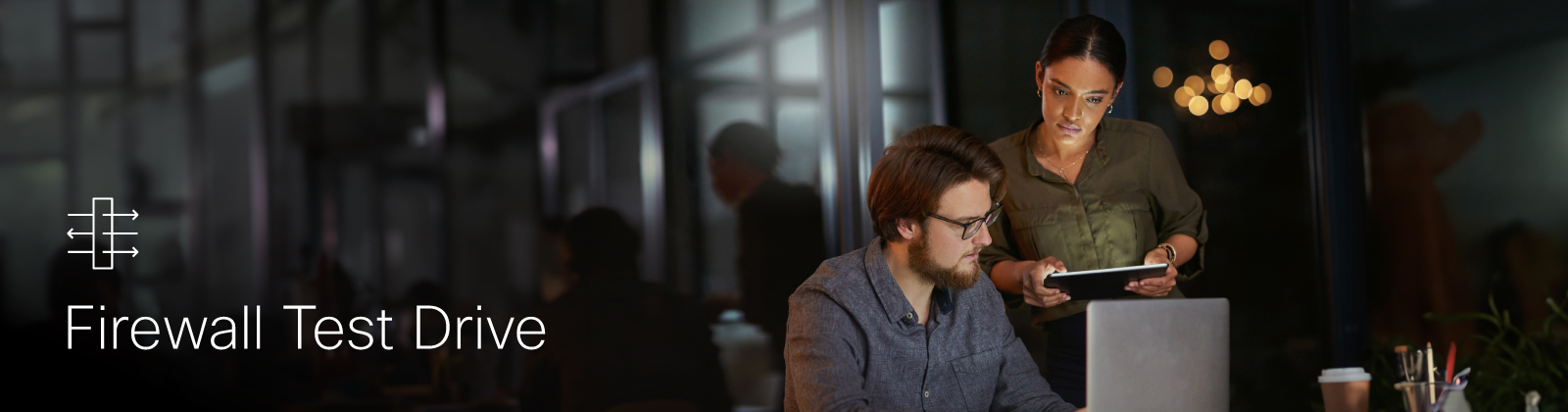 Two people standing and looking at a computer