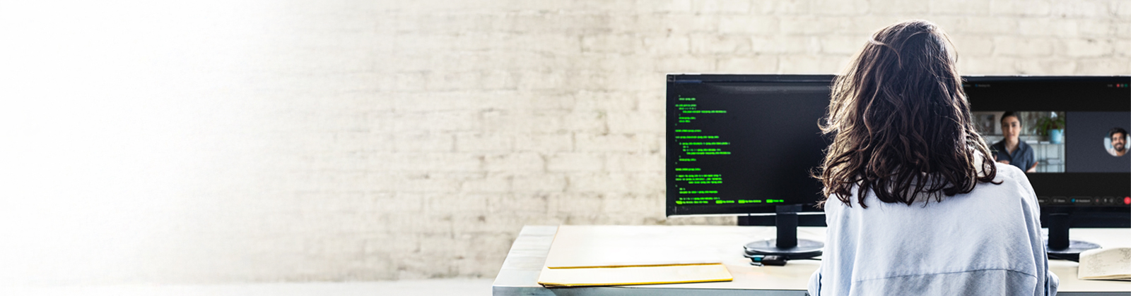 Woman working, looking at her screens