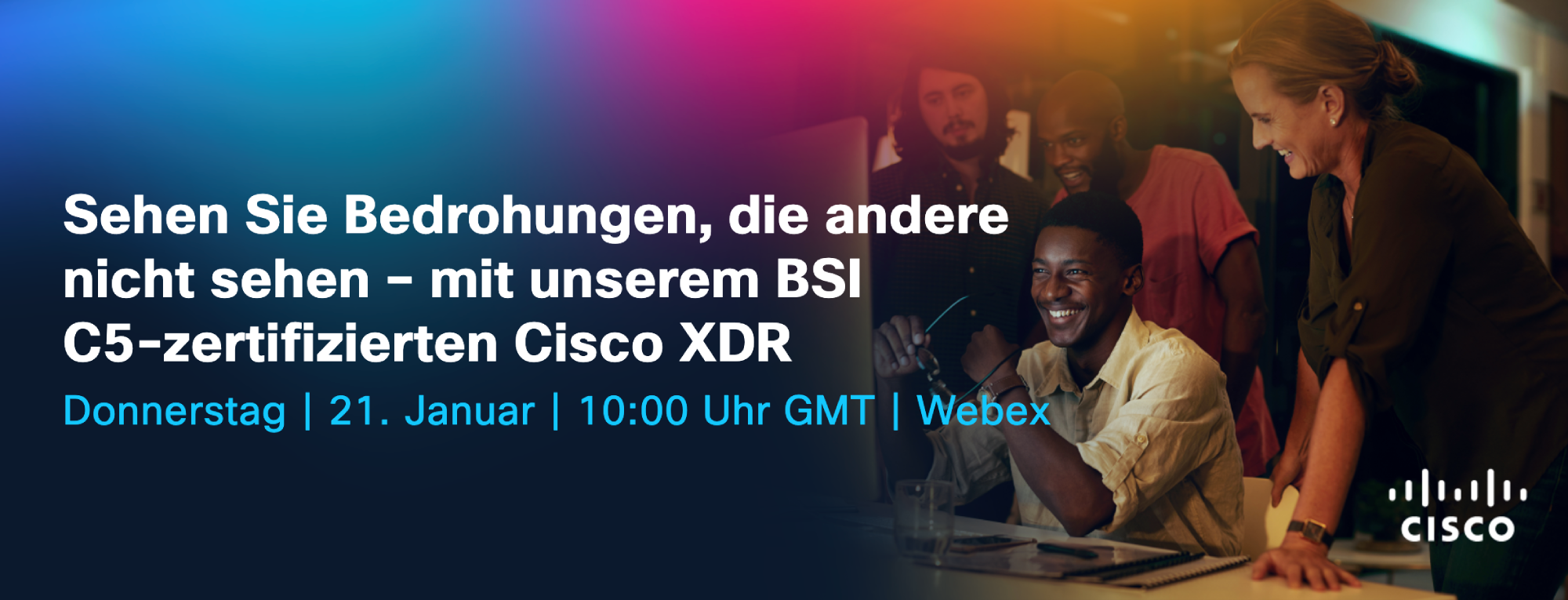 Multiple People sitting at a desk looking at a computer screen