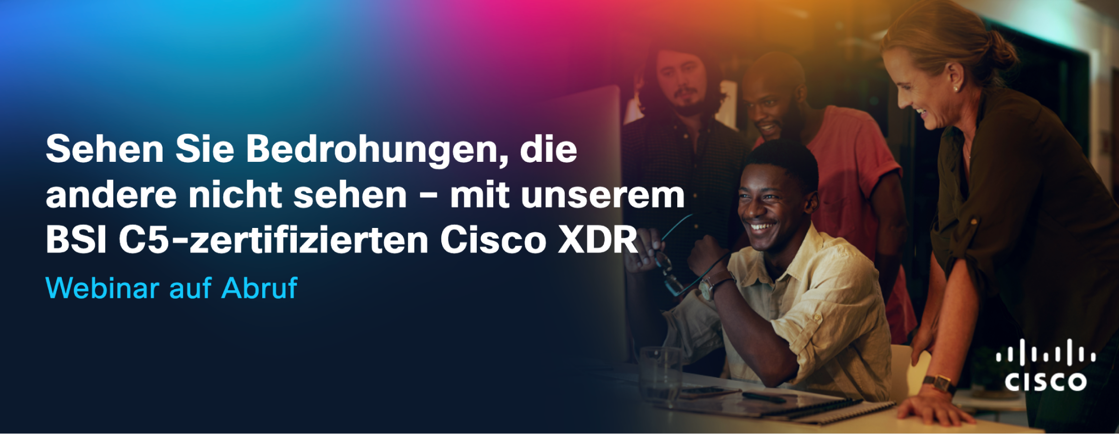 People sitting around a computer, smiling. 